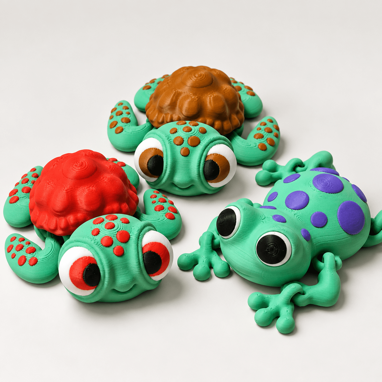 3D printed articulated turtle and frog fidget toys displayed together
