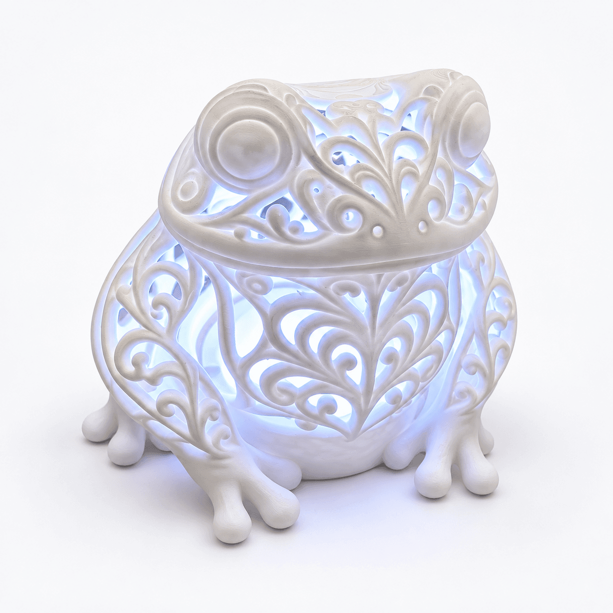 White filigree frog LED lamp glowing softly through intricate scrollwork