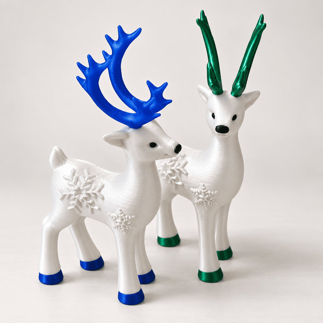 Pair of festive 3D printed reindeer ornaments with decorative antlers